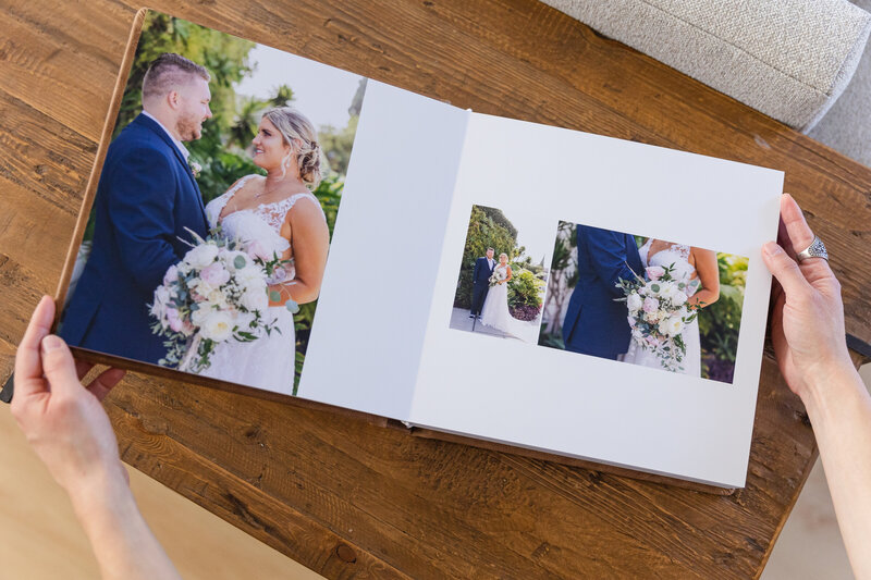 hands hold wedding album open showcasing wedding photography in LA