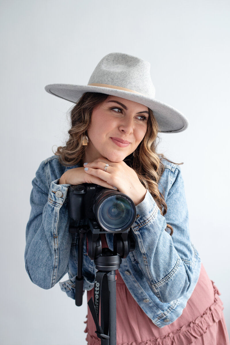 Woman smiling at camera wearing a hat