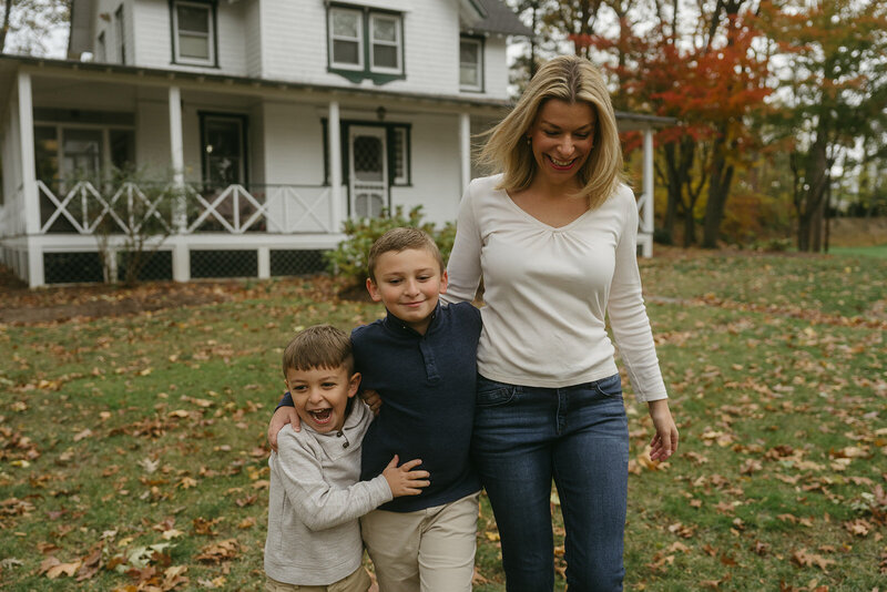 mom walks with two sons during family photography captured by NYC family photographer Elsie Goodman
