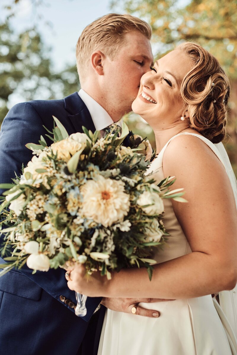 Groom Kisses Bride's Cheek at Kellogg Mansion in Kalamazoo, Michigan