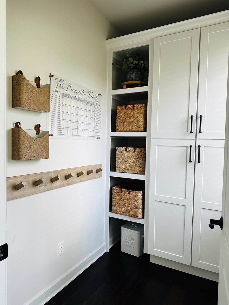 Crispy white cabinets and a shelf lined with textured baskets.