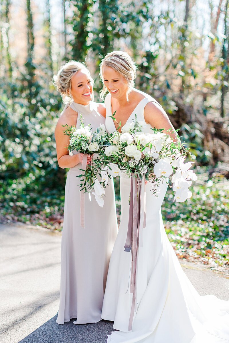 bride and maid of honor laughing by Knoxville Wedding Photographer, Amanda May Photos