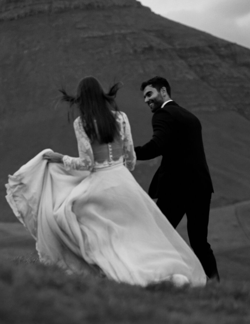 Faroe Islands elopement portraits – bride and groom laughing in the wind, by Kollar Photography.