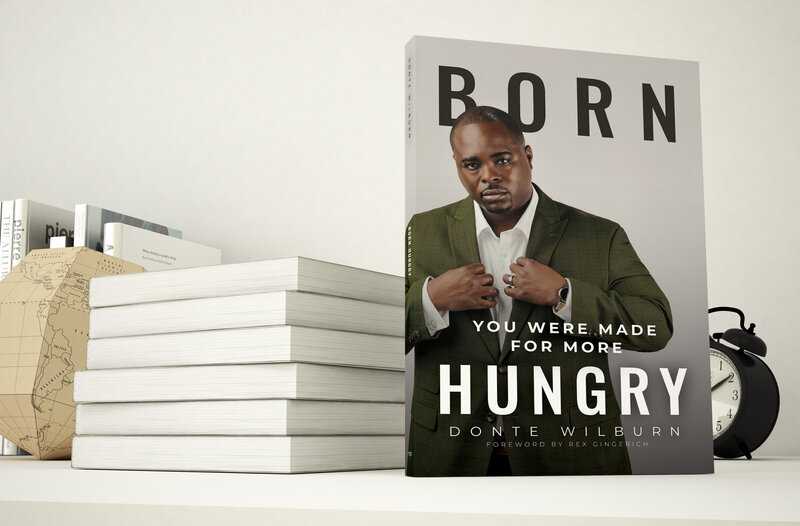 Born Hungry book standing next to stack of other books