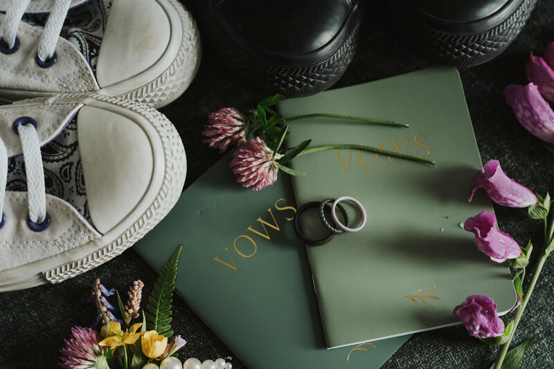 Lay falt of an elopement with rubber rings, converse shoes and vow books in Norway