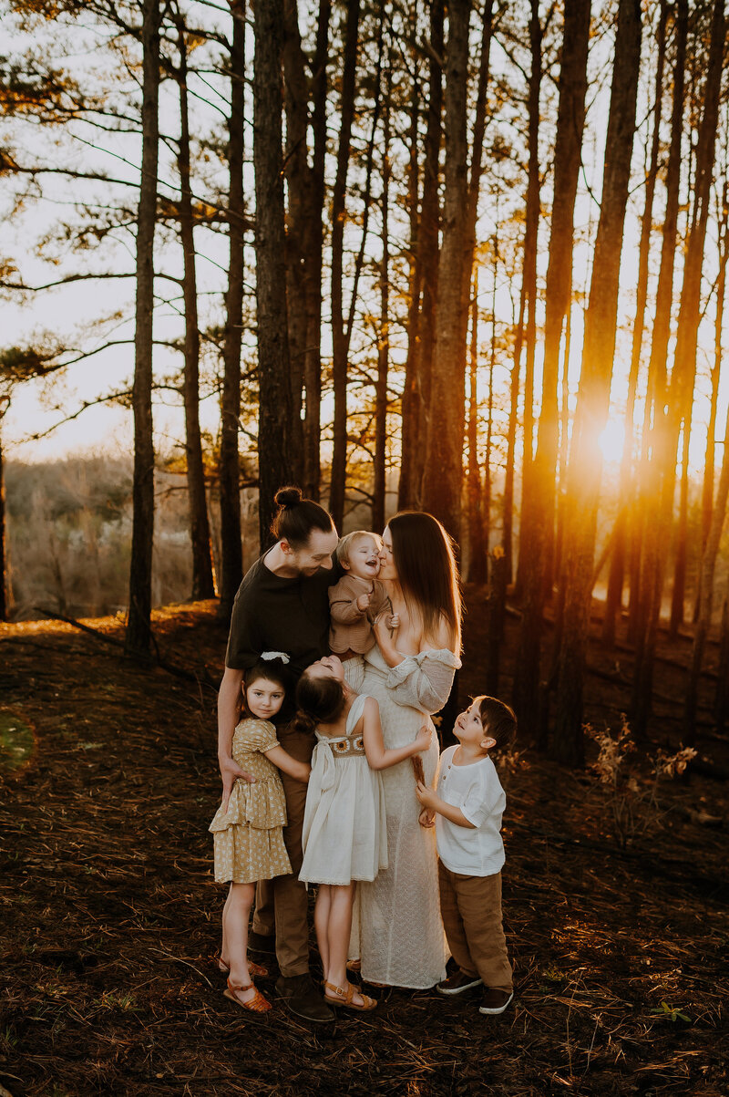 Mother holding her toddler girl close and smelling her hair.