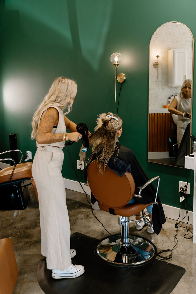 Group of talented hairstylists from The Vanity Hair Studio, Griffin, GA, specializing in haircuts, balayage, highlights, and Brazilian blowouts, creating a welcoming salon experience.