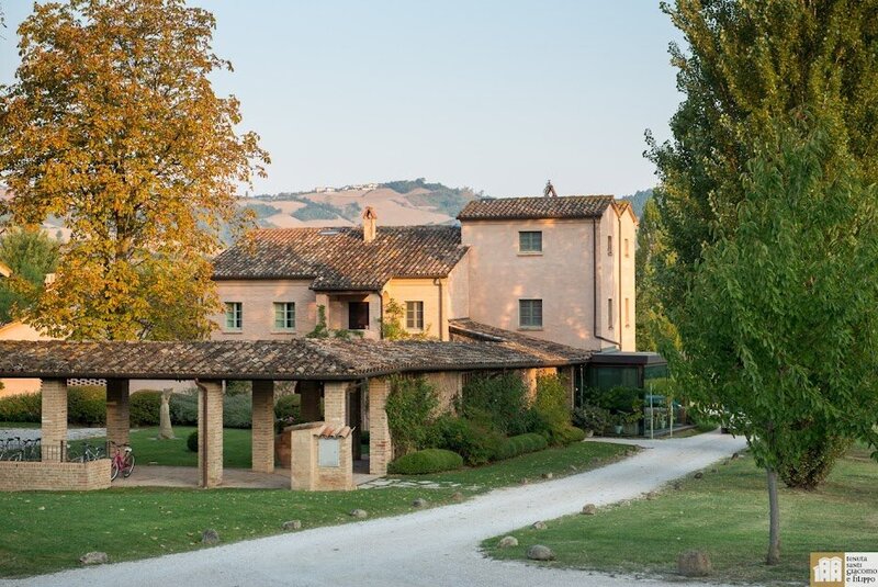 Exterior view of Tenuta Santi Giacomo e Filippo Wine Resort & Spa in the rolling hills of Urbino, Italy—an elegant countryside retreat featured on the Wish You WERE Here Italy Tour with author Christy Schillig.