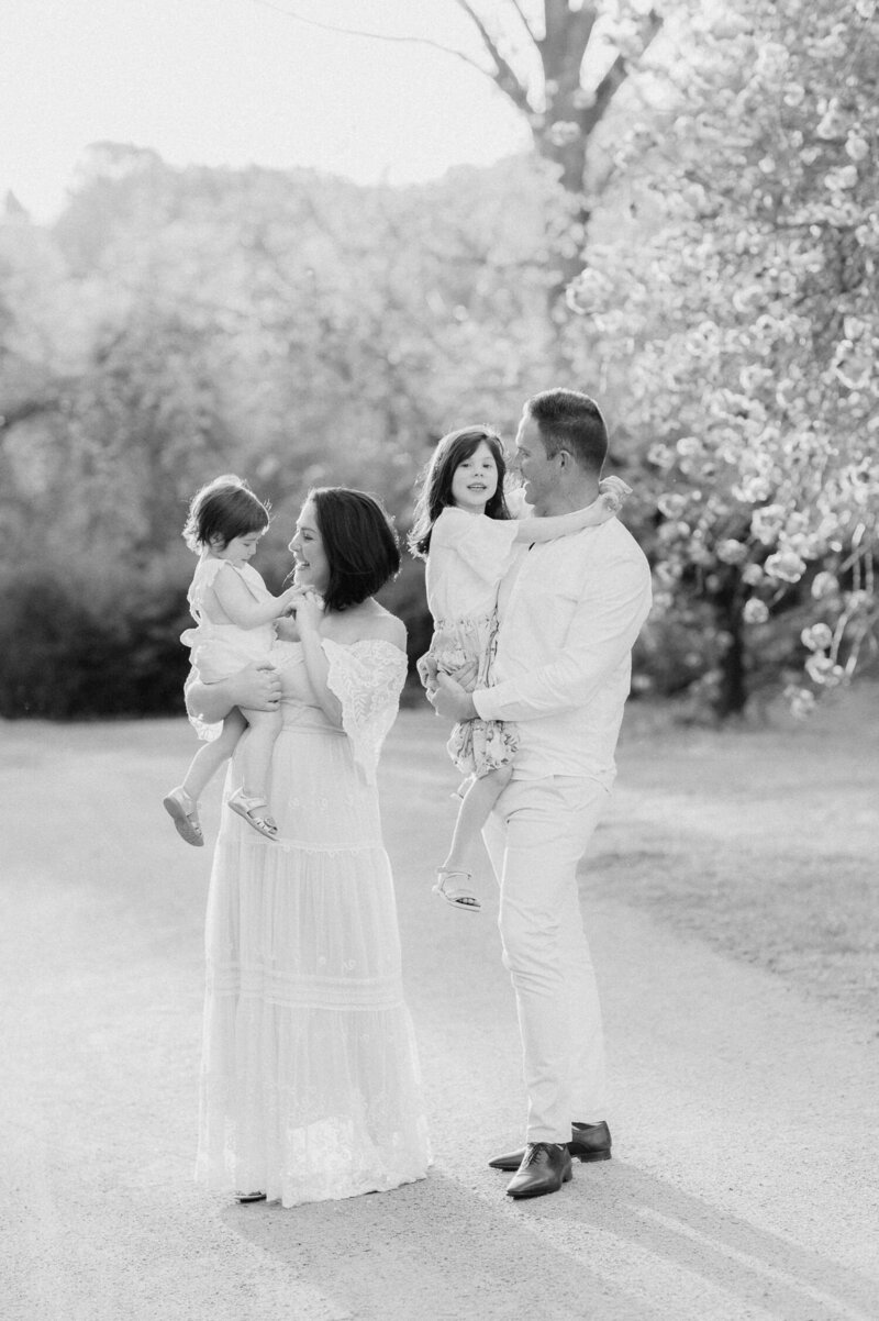 Black and white image of pregnant mother with hands on belly as photography by maternity photographer Sarah Vassallo
