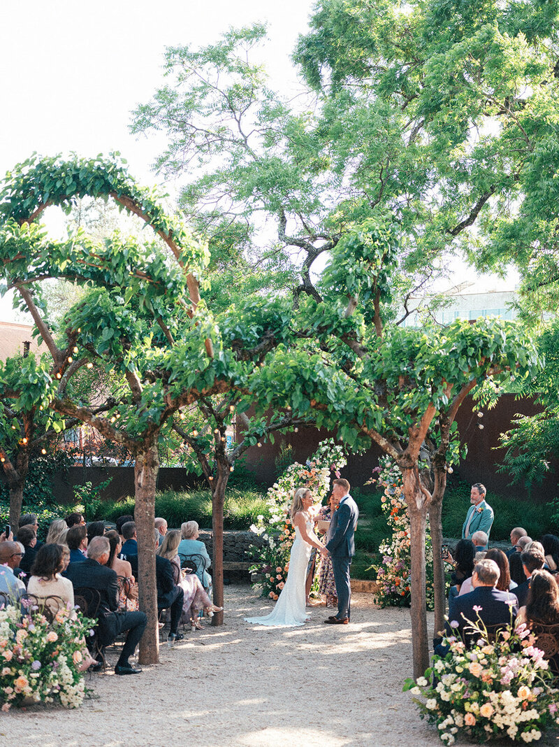 bride and groom holding hands at the altar