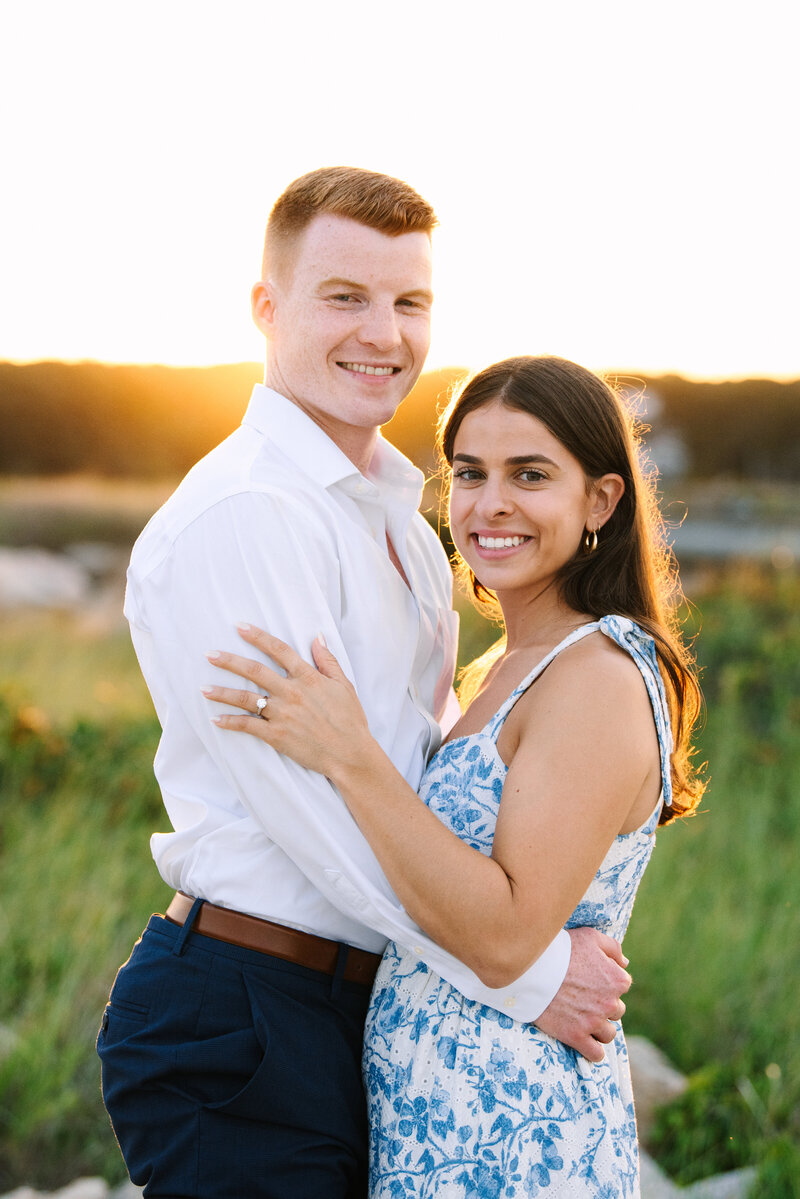 couple smiling at the camera during their menahaunt beach falmouth sunset engagement session