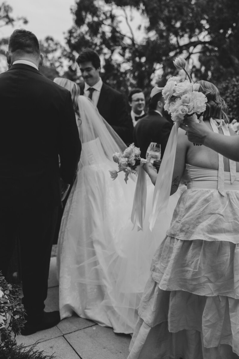 A bride and groom greet guests after saying their vows at St Lucia Gold Club in Brisbane
