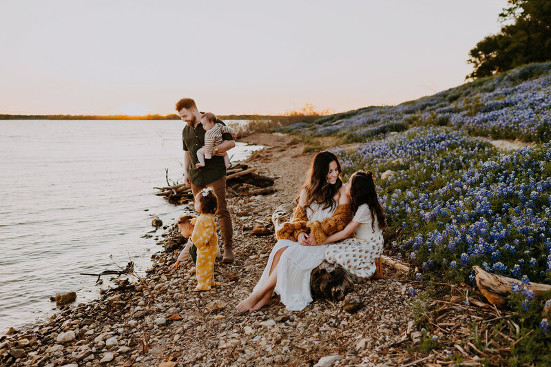 A family of five sitting in the blue bonnets near Lake Grapevine in Flower Mound, Texas