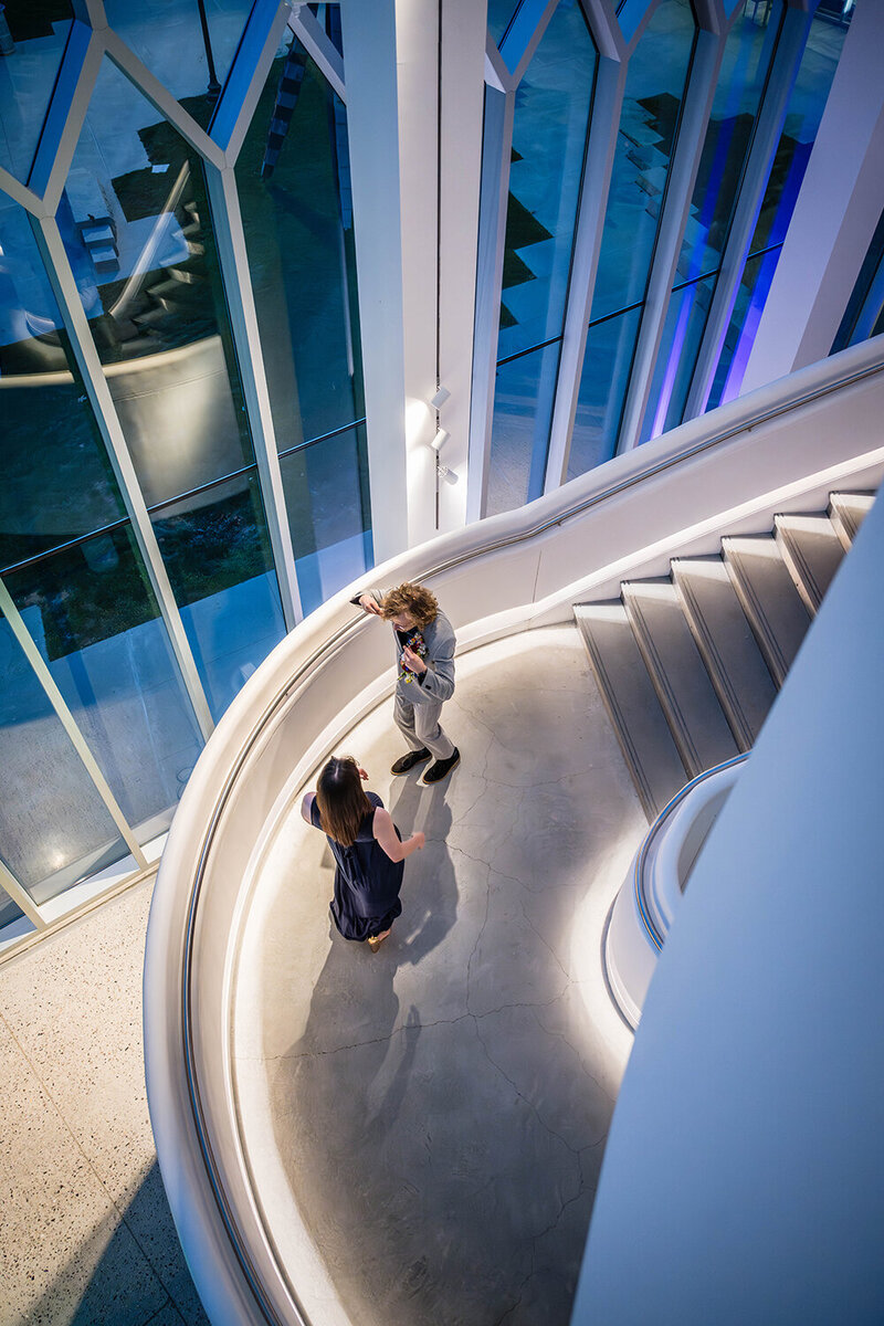A couple dances inside of the Moss Arts Center at night on their elopement day in Blacksburg.