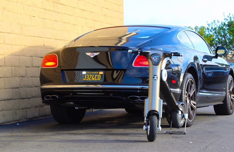 Grey Go-Bike M1 next to Bently