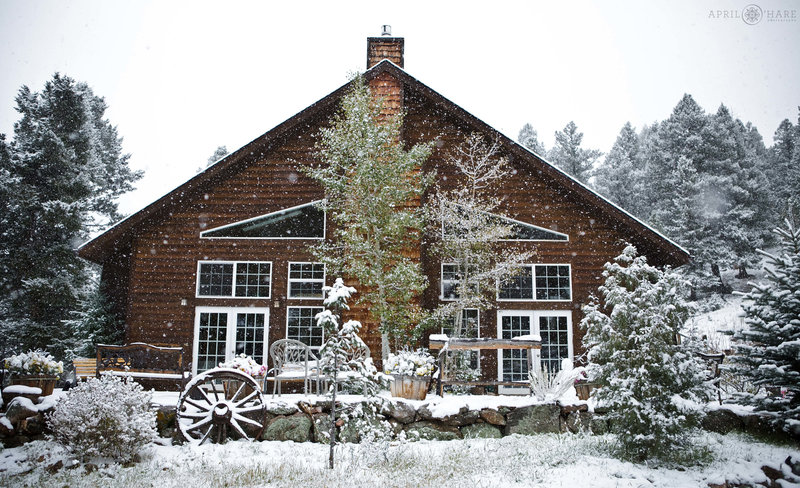 Rustic wood pavilion at Meadow Creek Lodge and Event Center on a snowy fall day in Colorado