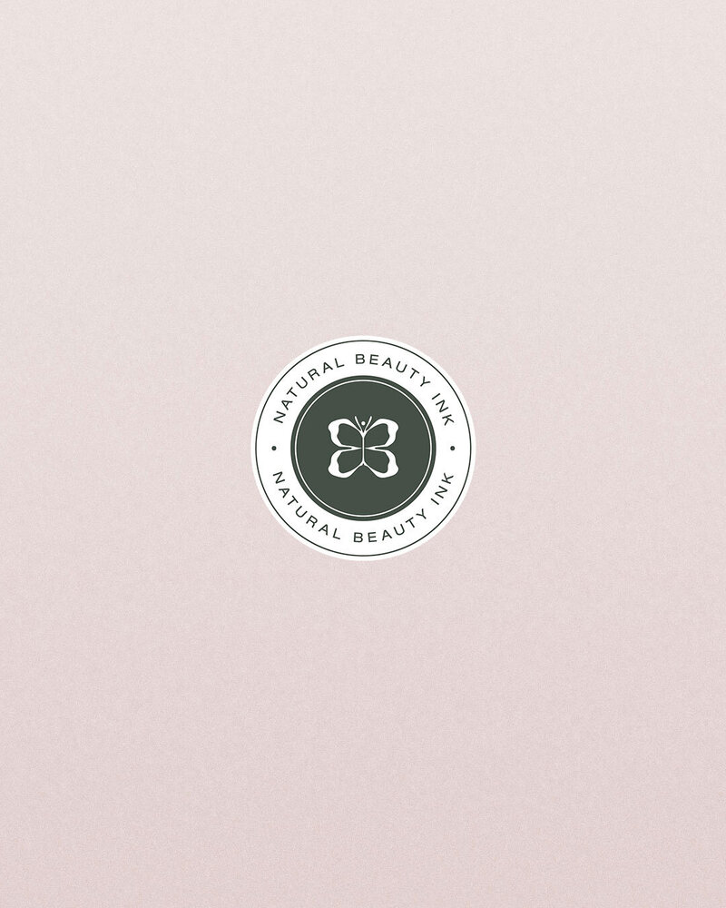 Green butterfly emblem submark on pink textured background for feminine brand identity