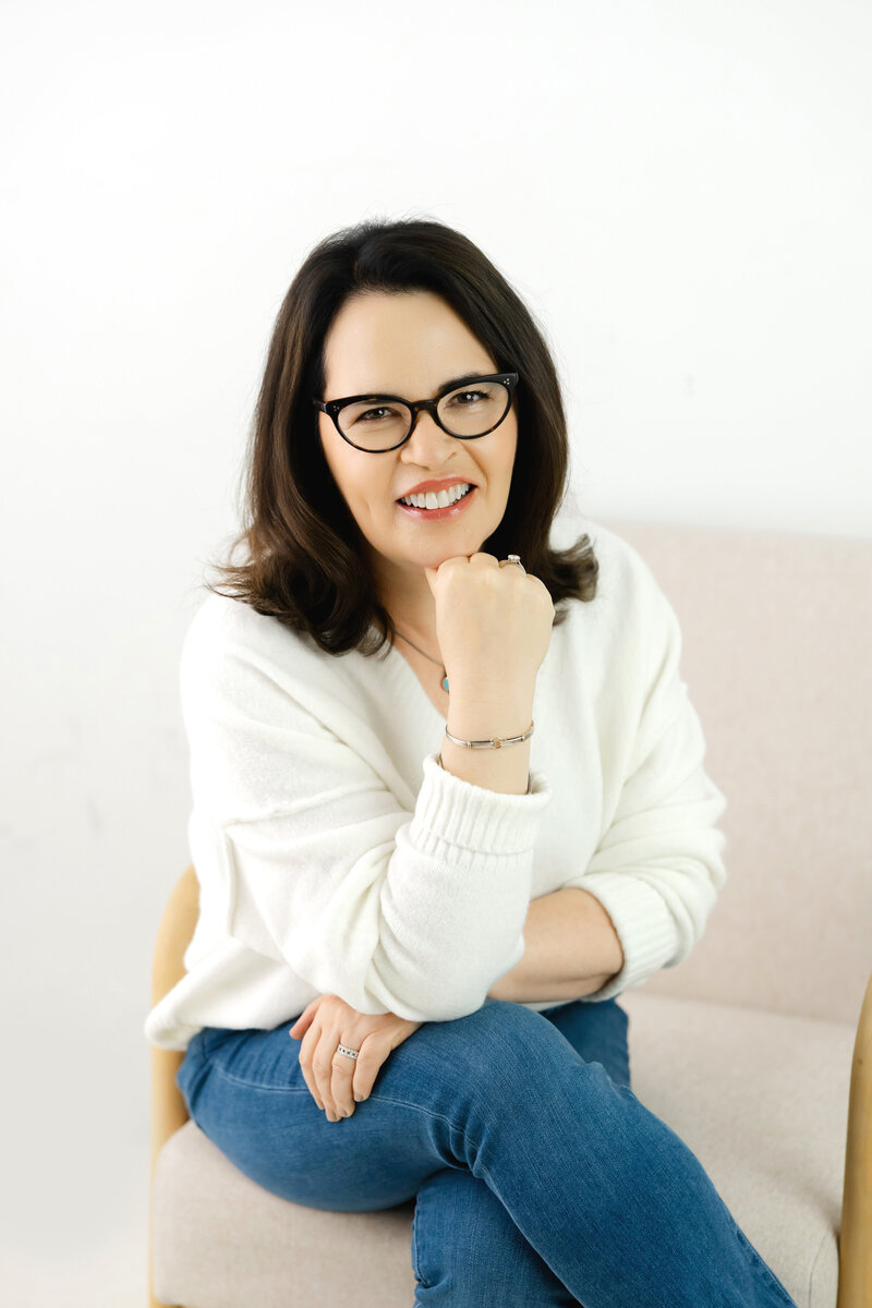 Leadership coach smiling confidently representing calm grounded executive presence