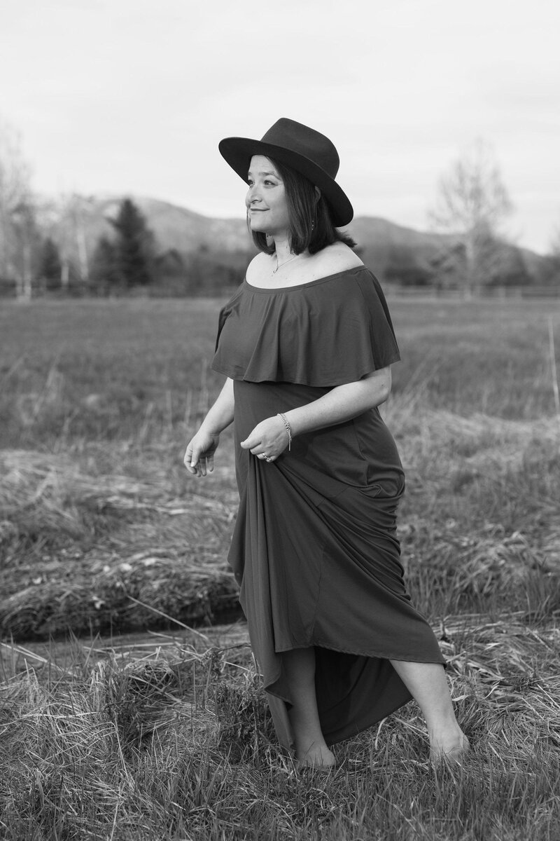 black and white image Jennifer posing in field