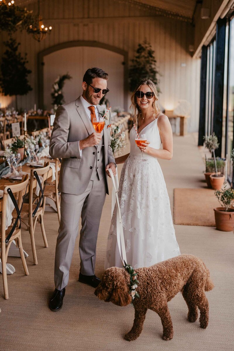 Stylish couple portrait with aperol spritz and dog