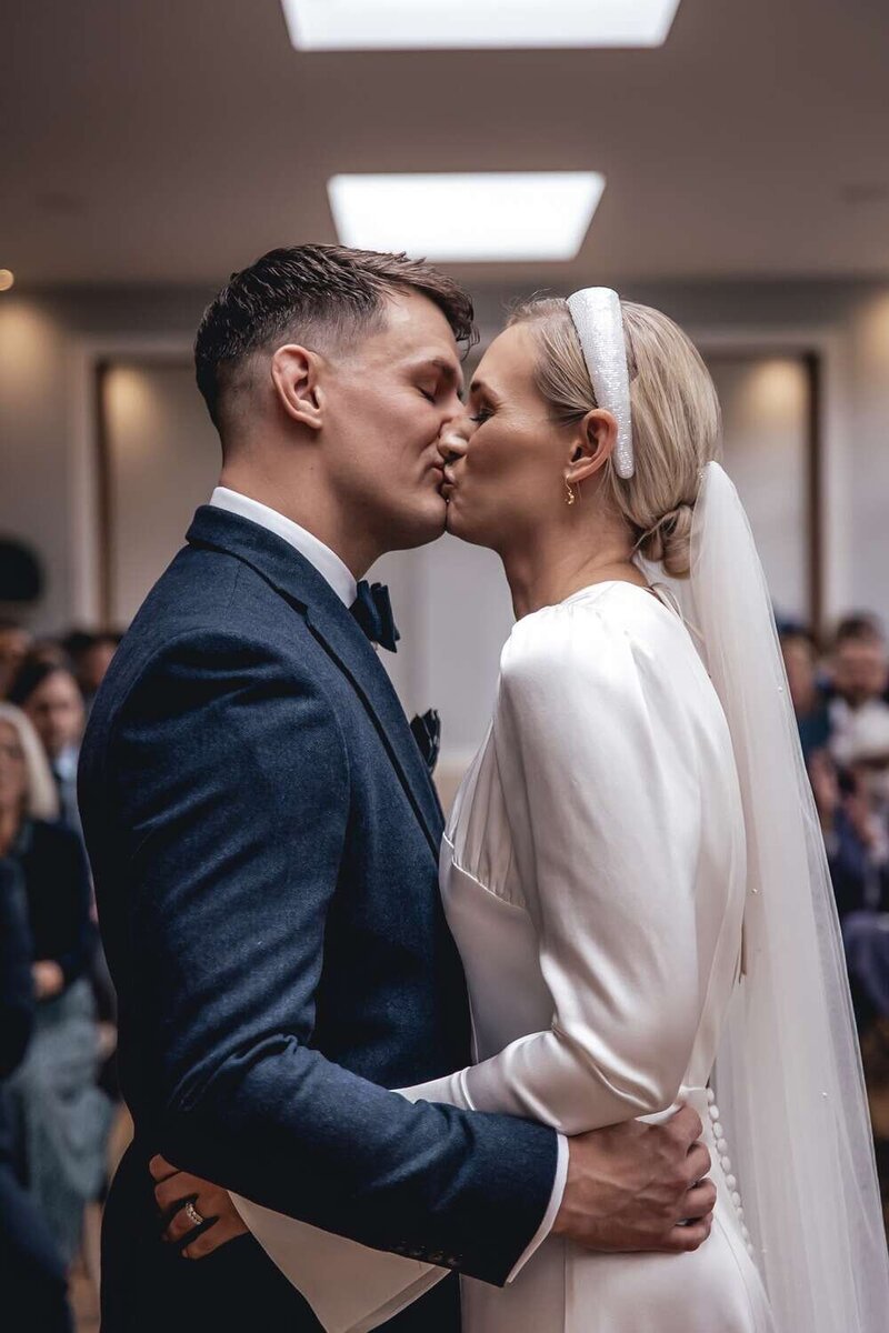 Bride & Groom kiss in wedding ceremony