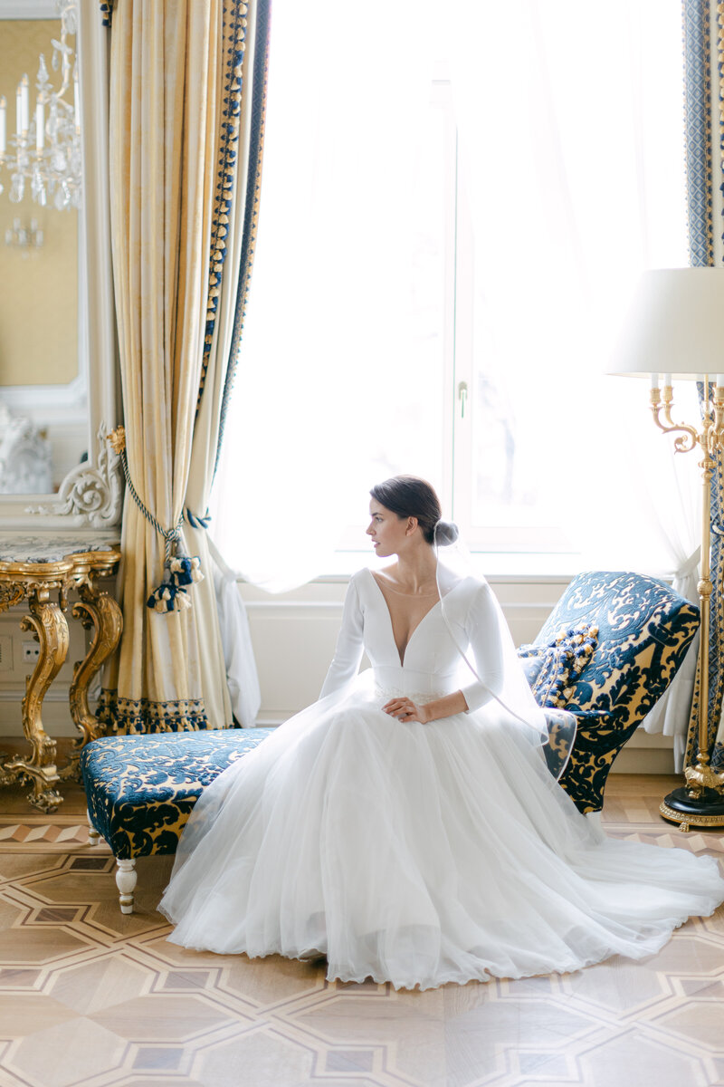 Luxury bride sitting on a chair at royal suite in Imperial Hotel Vienna executed by ECLAT Destination Weddings