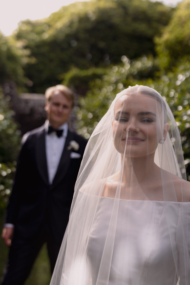 Wedding photographer captures couple taking a stroll hand in hand at their french chateau wedding.