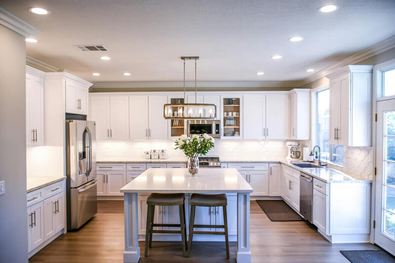 Photo of a freshly cleaned kitchen with bar stools at an island