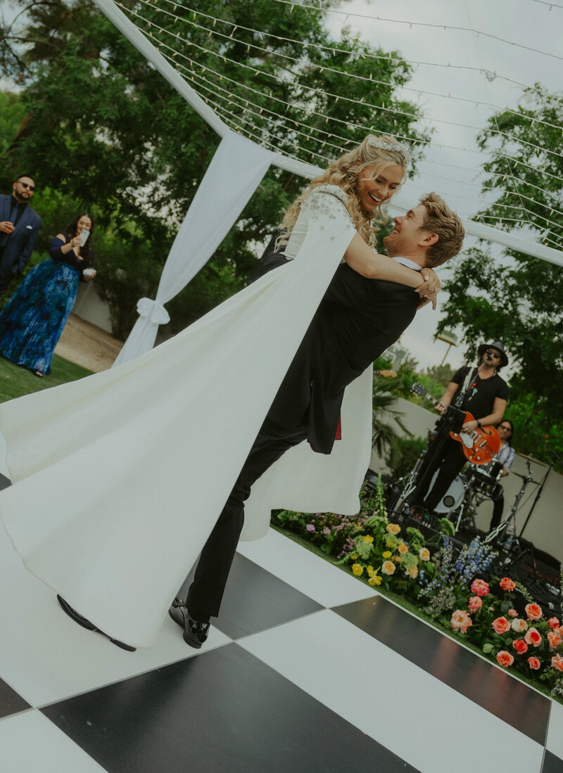 Bride and groom dancing at reception for first dance with custom planning and design by Satin & Slate Wedidngs.