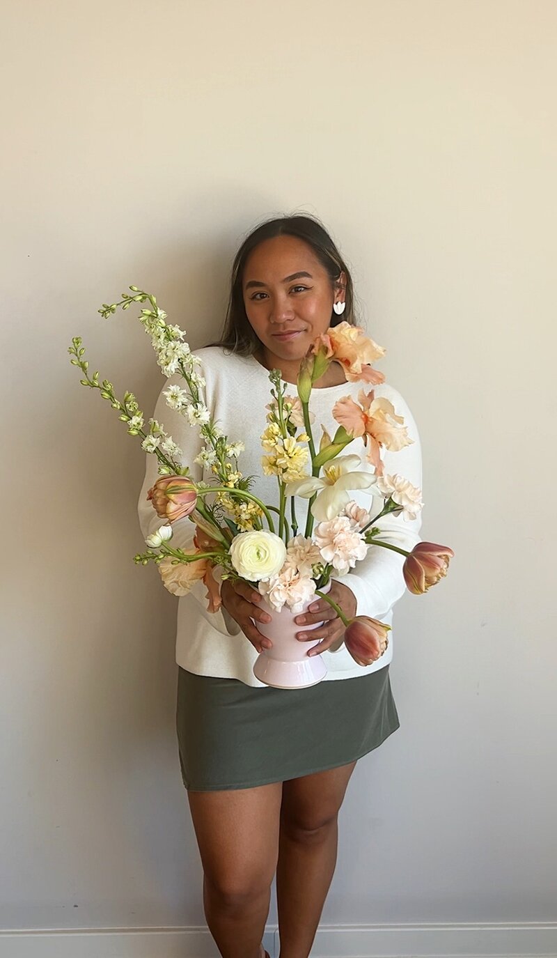 event planner holding a flower 