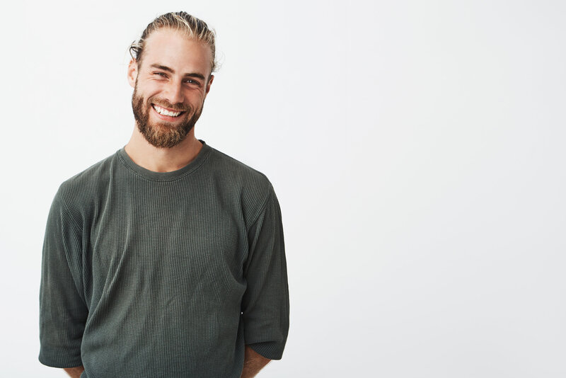 portrait-cheerful-handsome-bearded-guy-with-fashionable-hairstyle-smiling