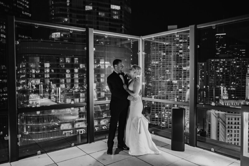 Bride and groom on the rooftop at night at Royal Sonesta