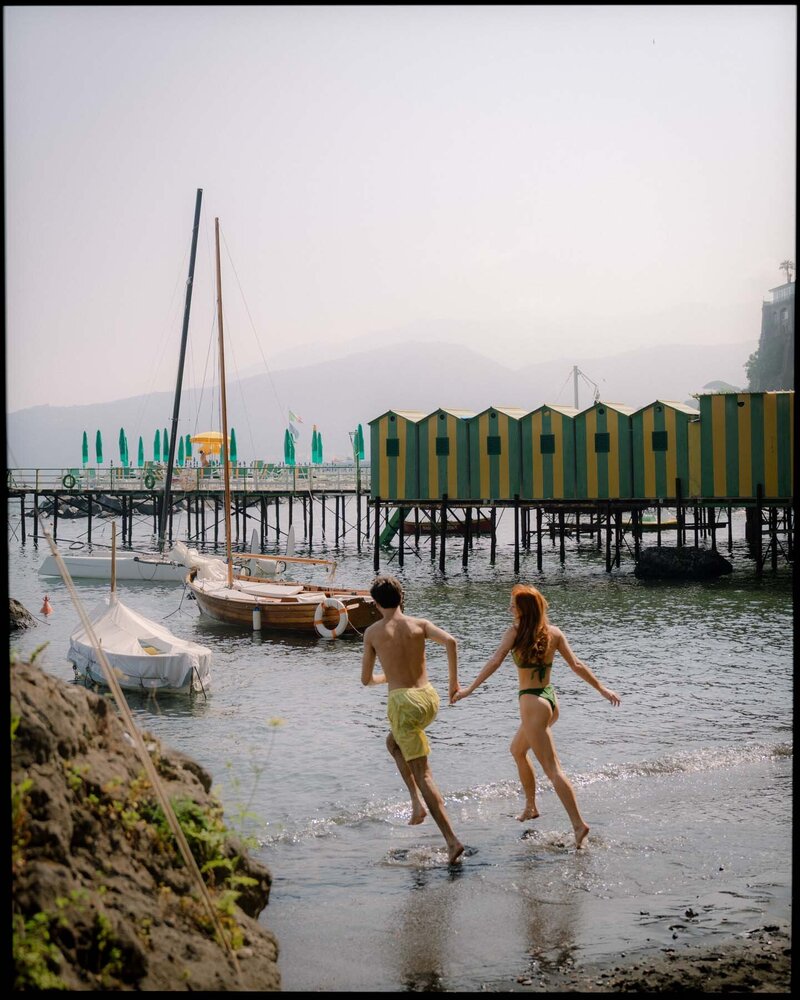 Young couple on beach in Hawaii during engagement session on Oahu.