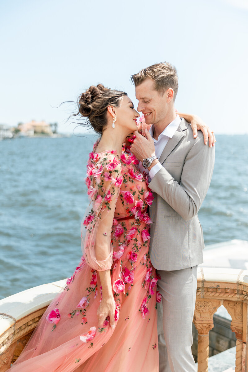 photo of a couple in vibrant outfit with ocean in the back by orlando wedding photographers