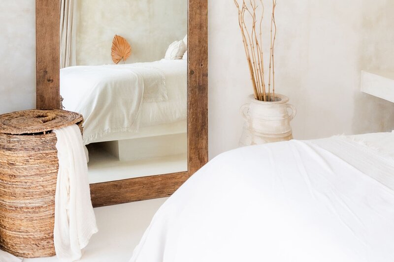 Functional bedroom design featuring white linens and wood accents for peaceful living