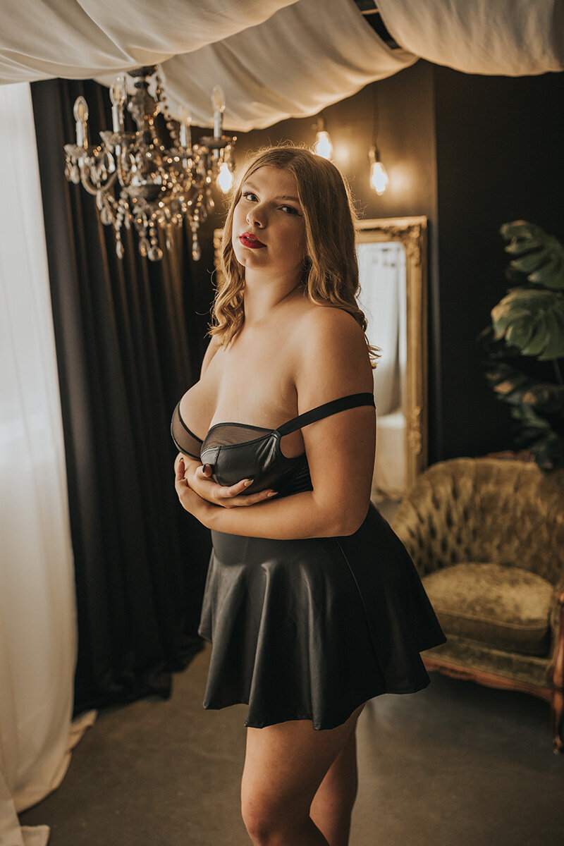 boudoir client posing in leather outfit
