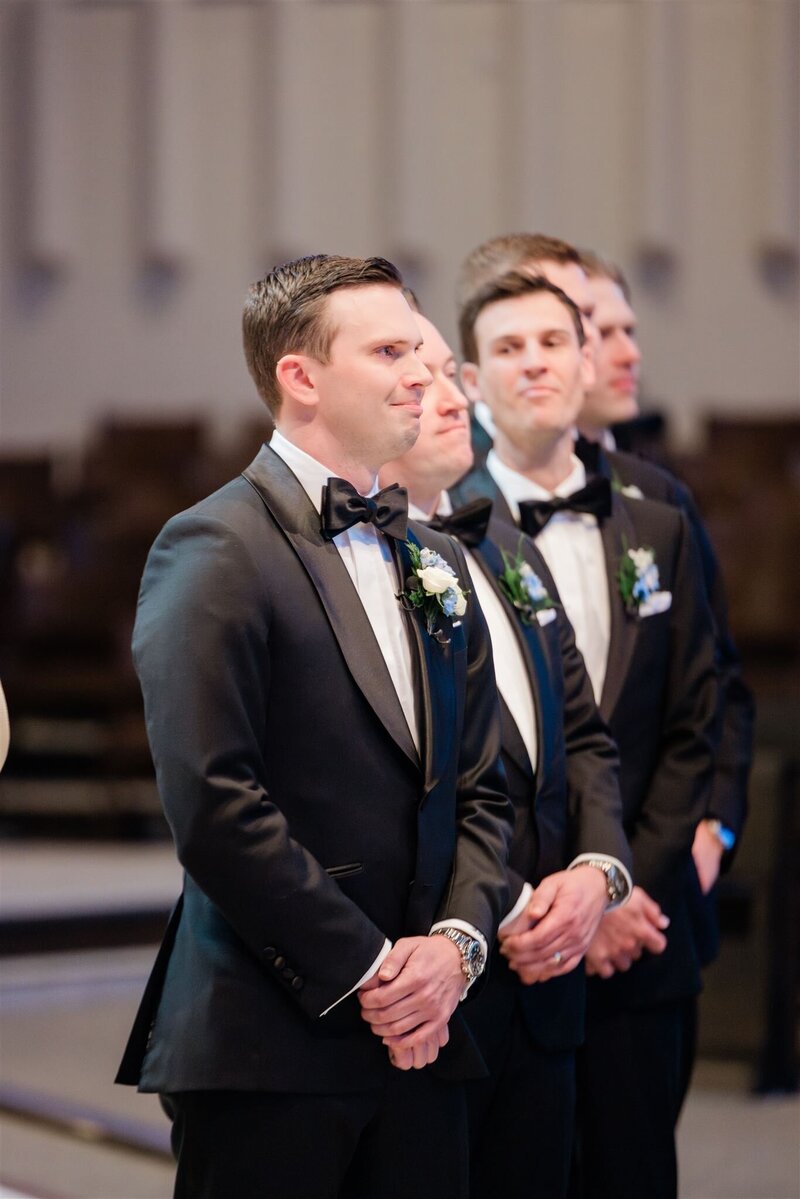 Groom watching his bride walk down the aisle at a Catholic Church in Winter Park. 