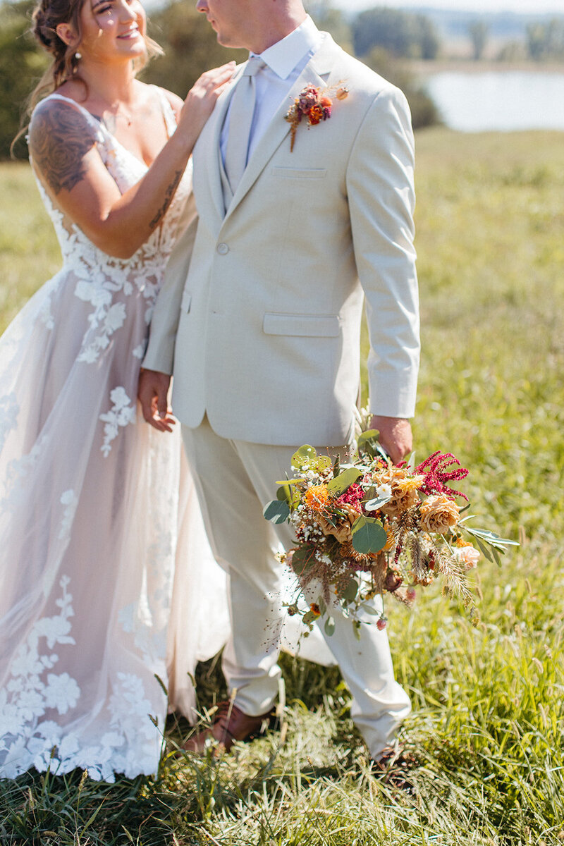 groom holding flowers St. Louis Wedding Photographers