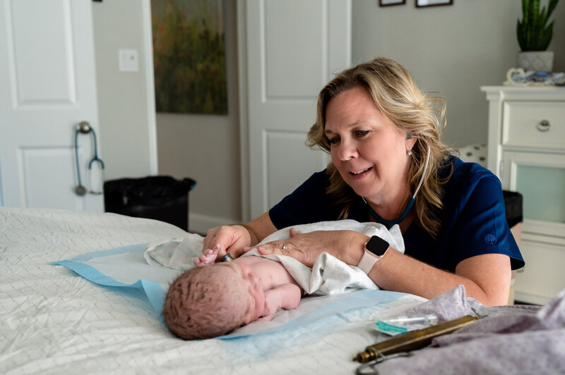 Joani Koenig performs a newborn exam at a homebirth in New Braunfels TX