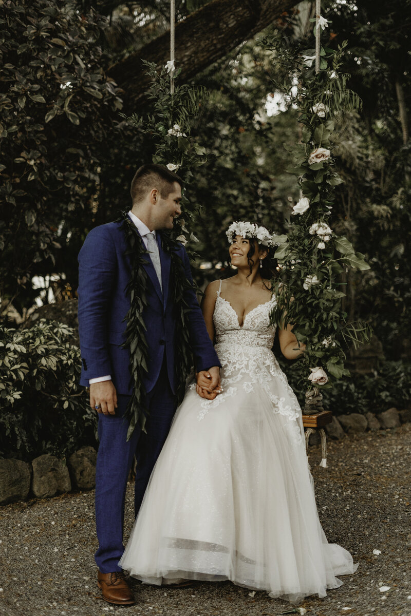 Bride and groom on swing at Loulu Palm Estate
