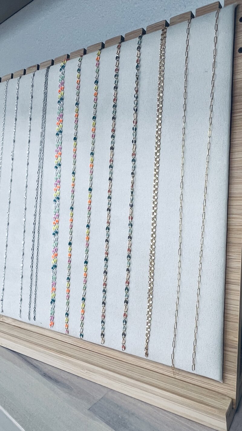 Delicate gold chain being welded on for a custom-fit permanent jewelry piece at Tailored + Co
