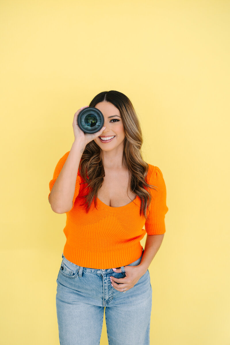 Photographer posing with her camera lense