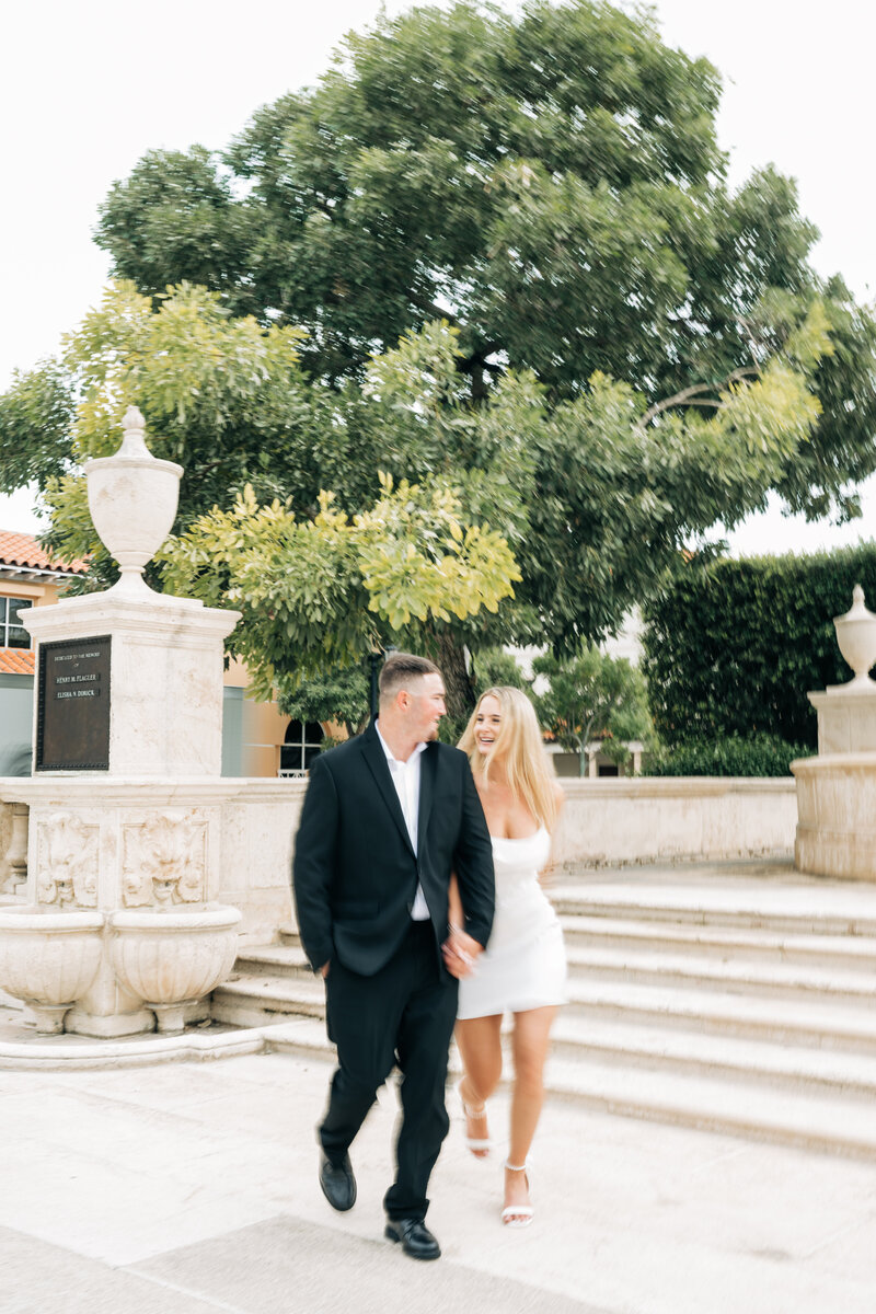 Couples walking at their engagement session captured by palm beach wedding photographer