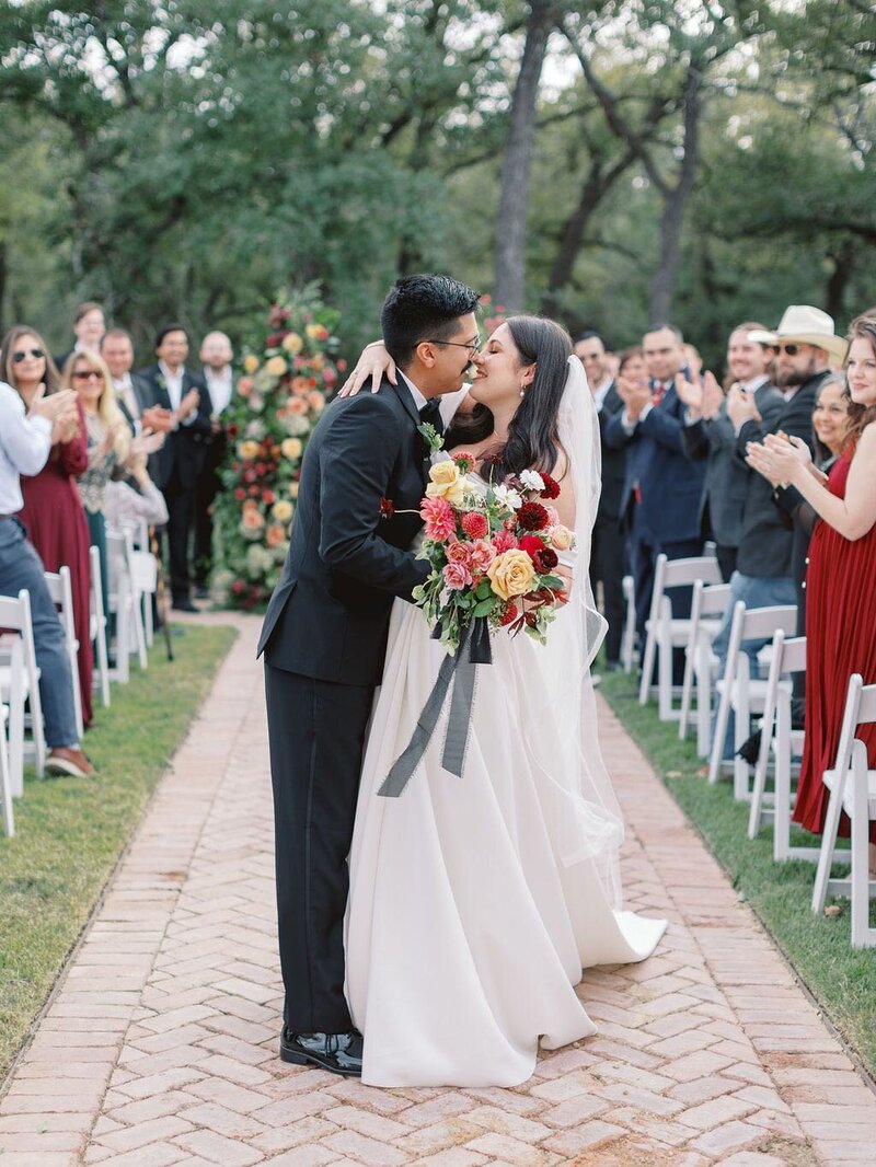 wedding-ceremony-brid-and-groom-kiss-down-aisle