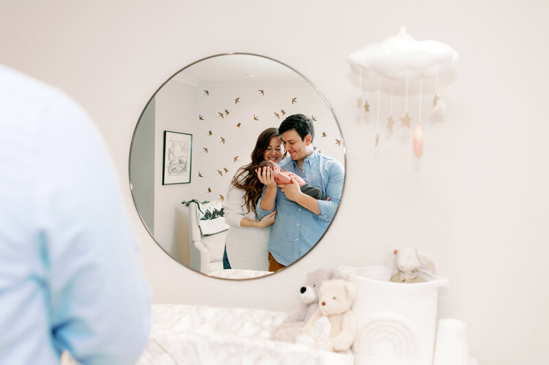 bay area photographers captures groom in his suite at the beginning of his wedding day holding a drink and looking out the window while in a tux for wedding portrait