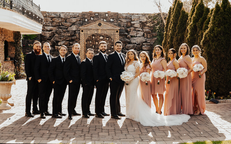 bride and groom posed with wedding party