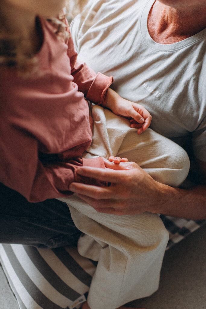 Dad is holding daughters hand in a Scottsdale home