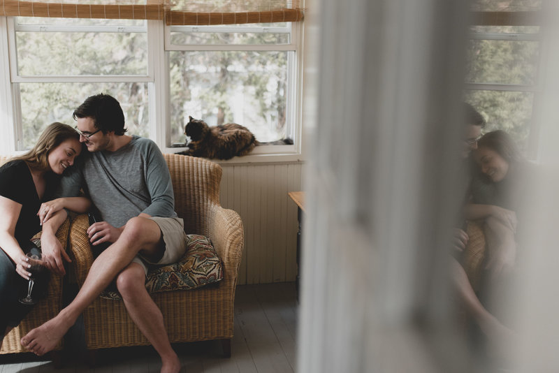 Cozy couple in house during engagement shoot