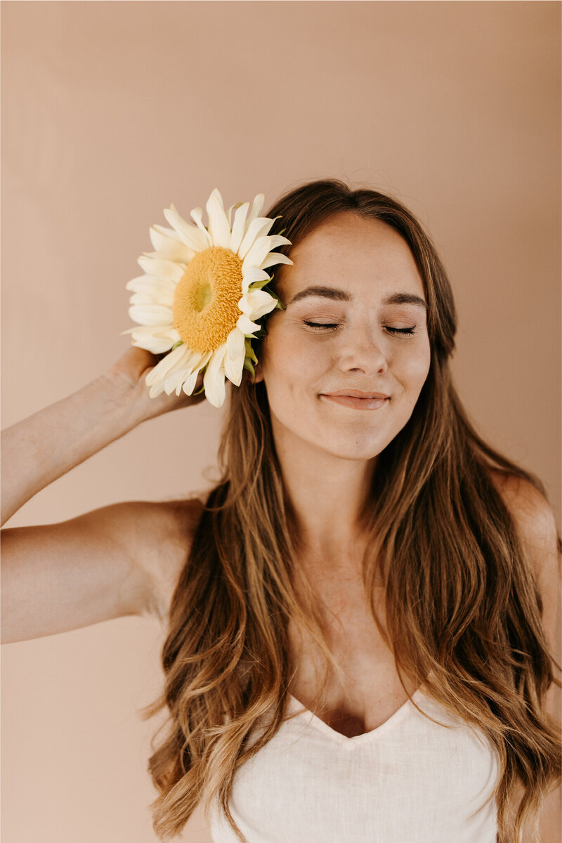 portrait of woman with flower in here bair