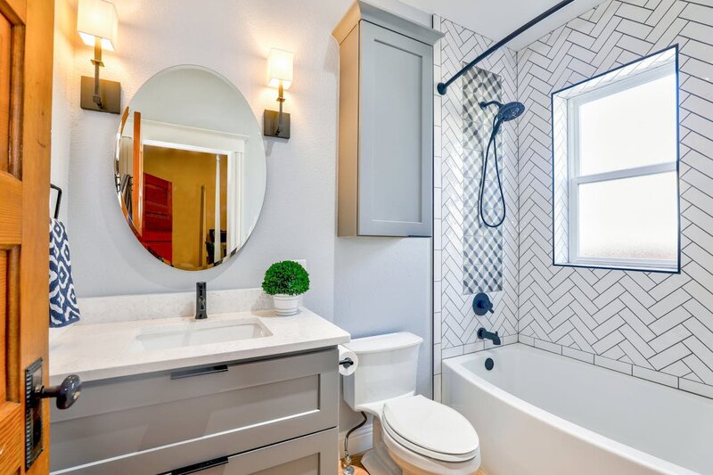 a bathroom with tub, shower, toilet, sink and a vanity. 